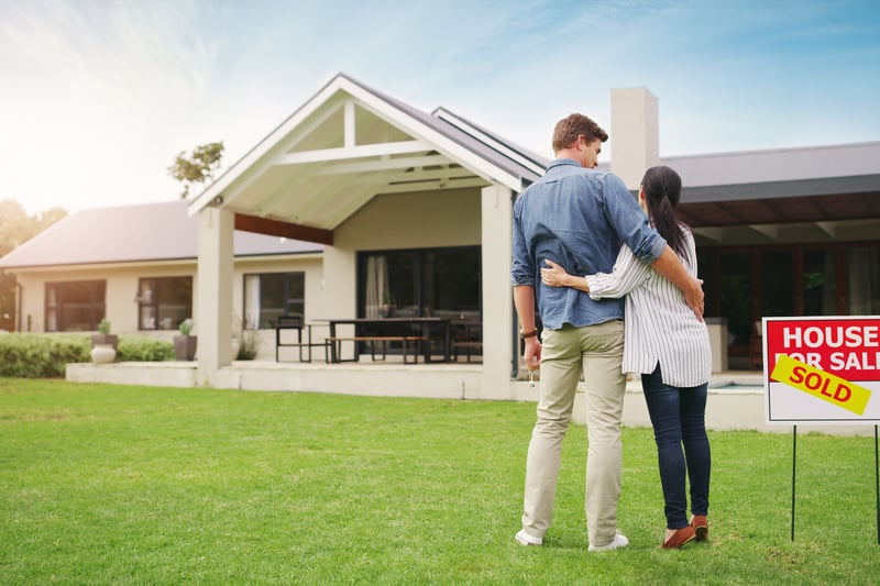 A couple looks at a newly sold house.