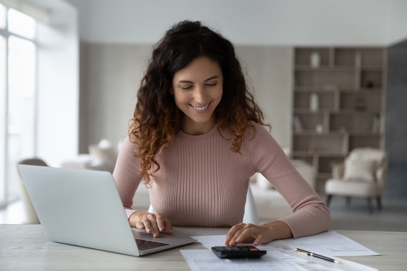 A woman smiles while estimating how much house she can afford.