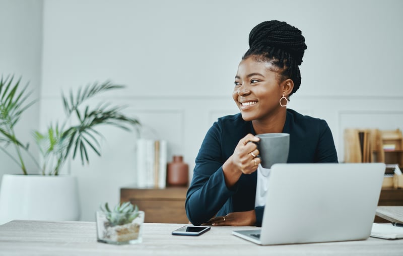 A woman smiles while checking her reserves for a mortgage.