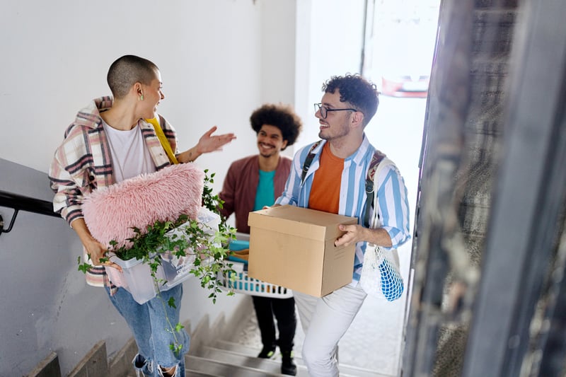 People smile while moving into a home purchased with a VA loan.