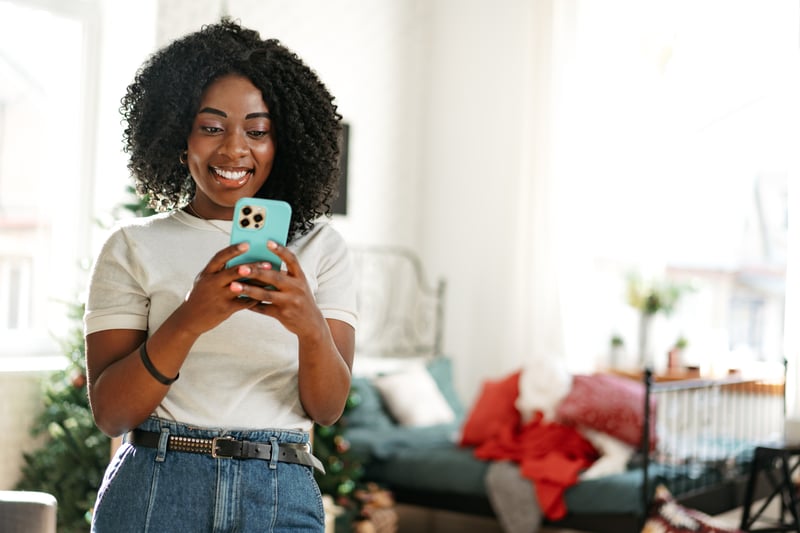 A woman smiles while comparing 401k loans and HELOCs.