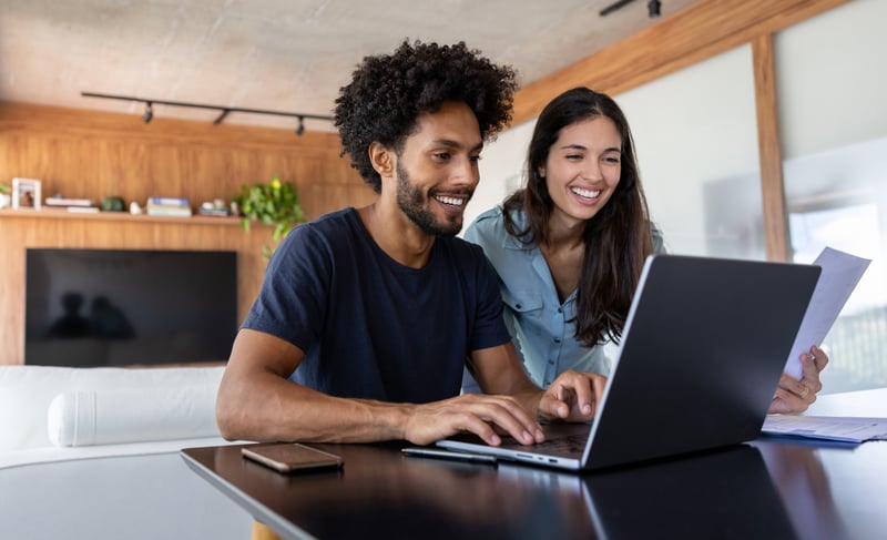 A man and a woman smile while applying for a 10/1 ARM.