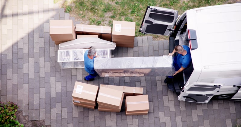 People load boxes into a moving van.