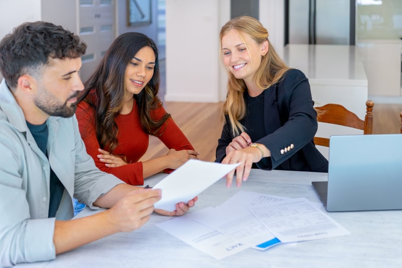 People smile while closing on a home loan.