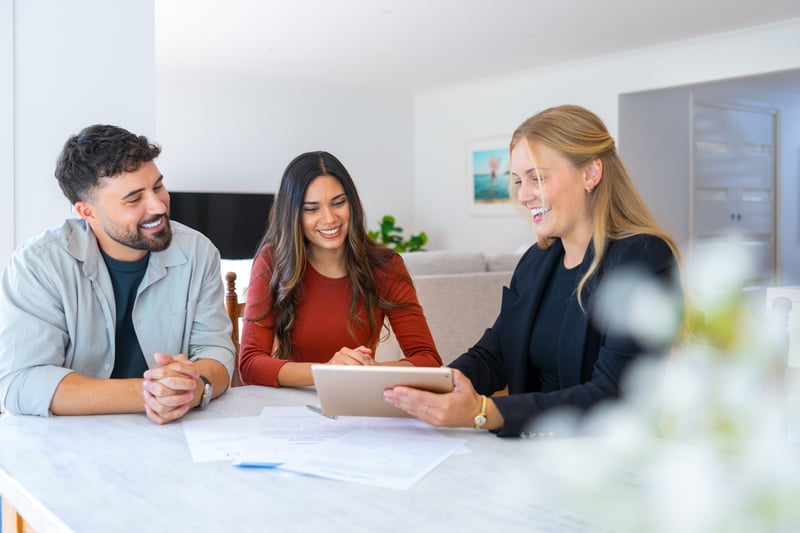 People sign for a mortgage with a loan officer.