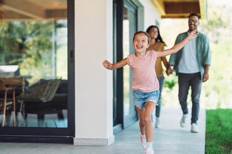 A family runs into their new home.