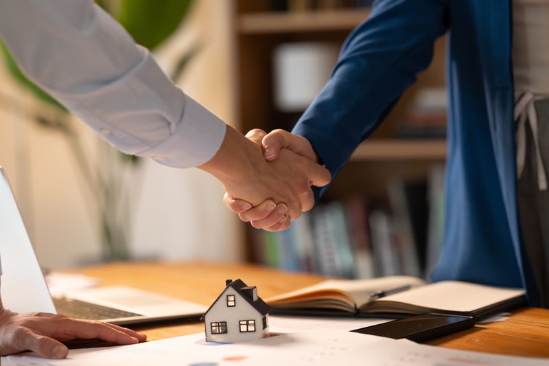 People shake hands while closing on a home equity loan.