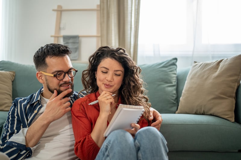 A couple smiles while exploring their options for assuming a mortgage.