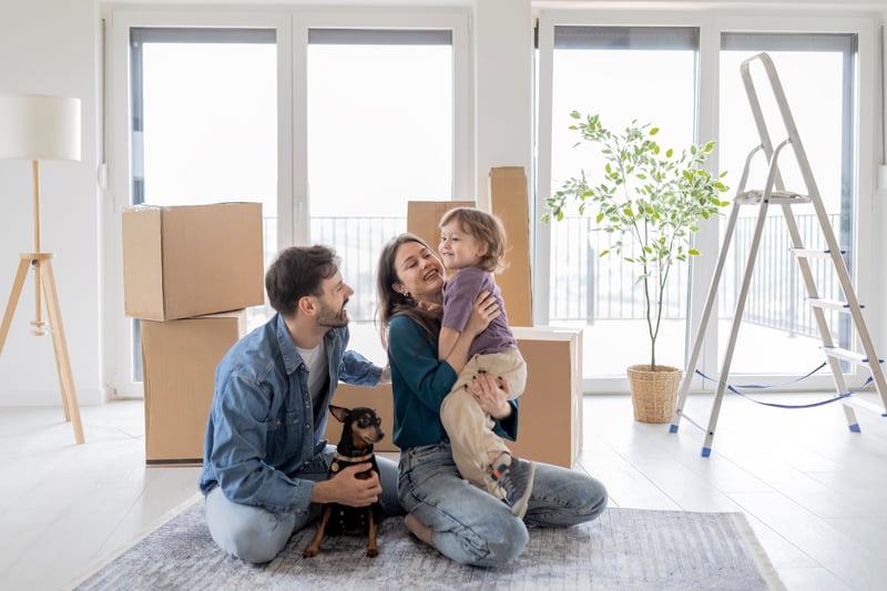 A family moves boxes into a new house.