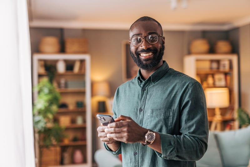 A man smiles after locking in a mortgage rate online.