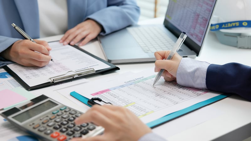 Underwriters go through financial documents.