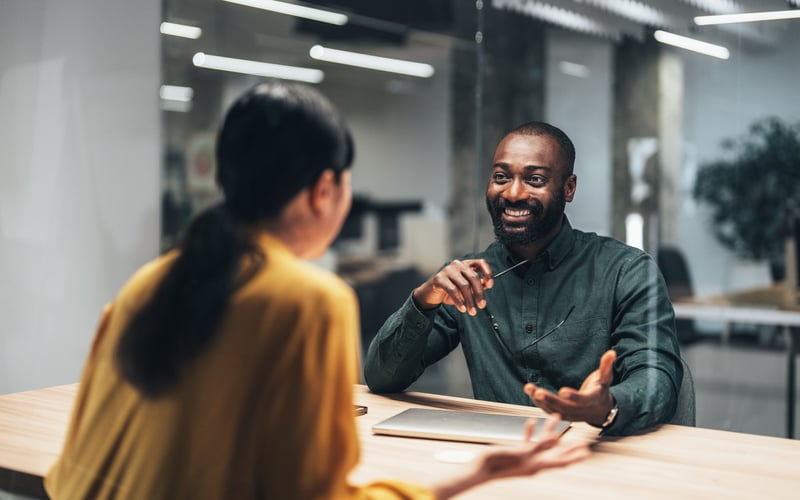 A mortgage underwriter speaks with a loan officer.