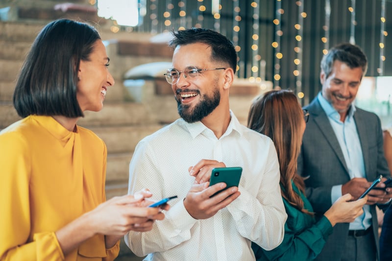 A man and a woman smile while comparing refinance rates across products.