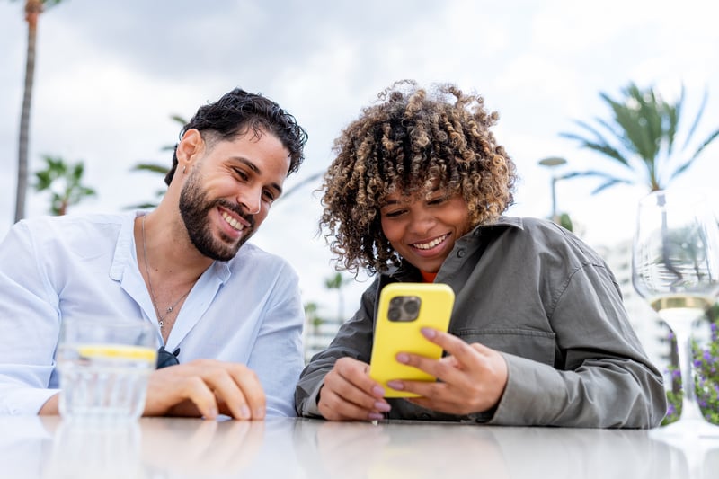 A man and a woman smile while comparing refinance rates in South Carolina.