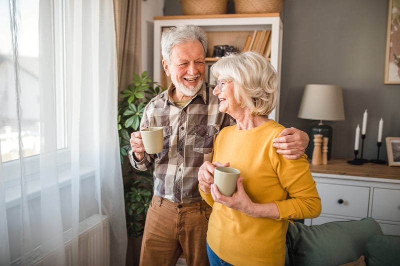 A senior couple drinking coffee in the living room 