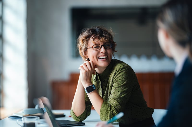 A borrower smiles while comparing conventional and bank statement loans.