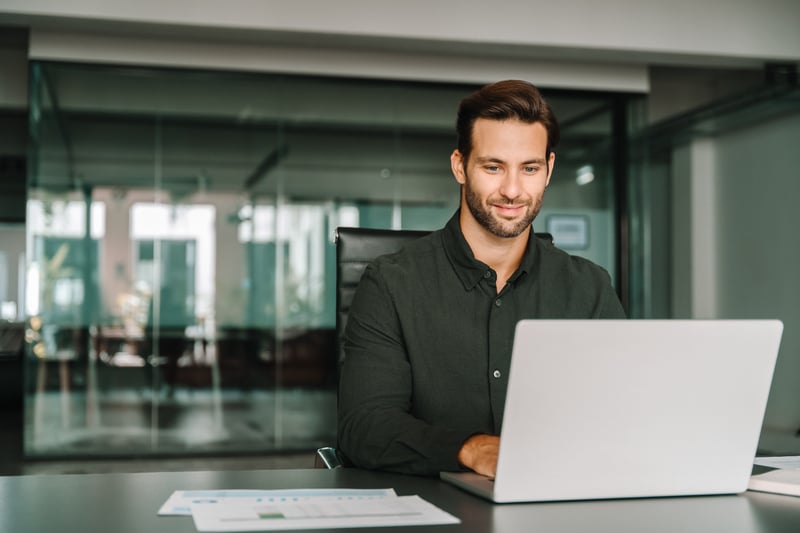 A underwriter works at his desk.