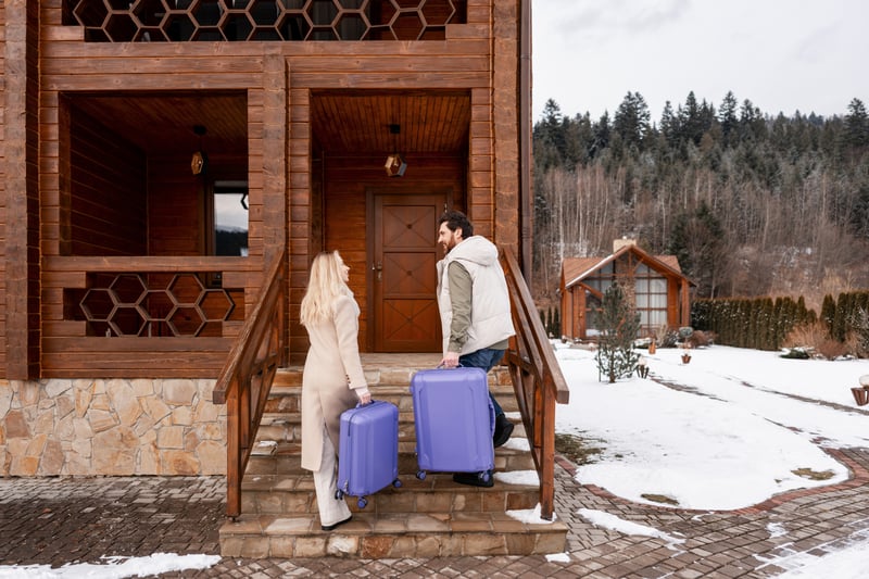 People carry suitcases into a short-term rental house.