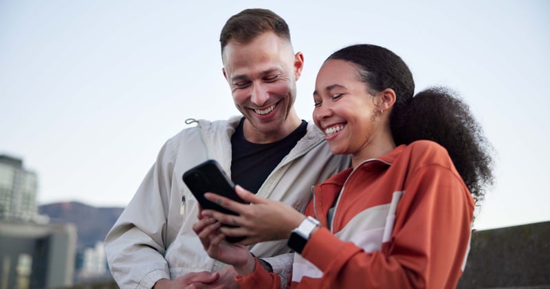 A man and a woman smile while learning about Oklahoma refinance rates.