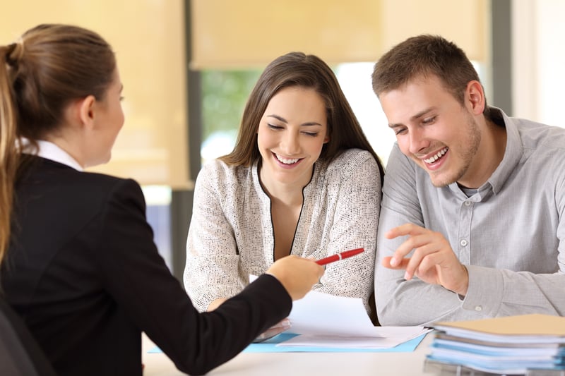 People smile while closing on a VA loan.