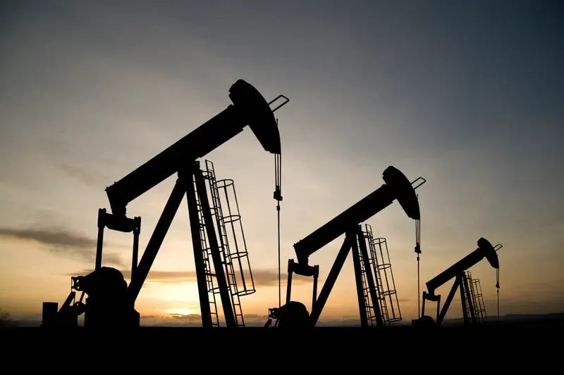 Oil pumps seen at sunset.