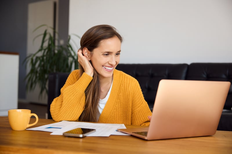 A woman smiles while shopping for a second home loan.