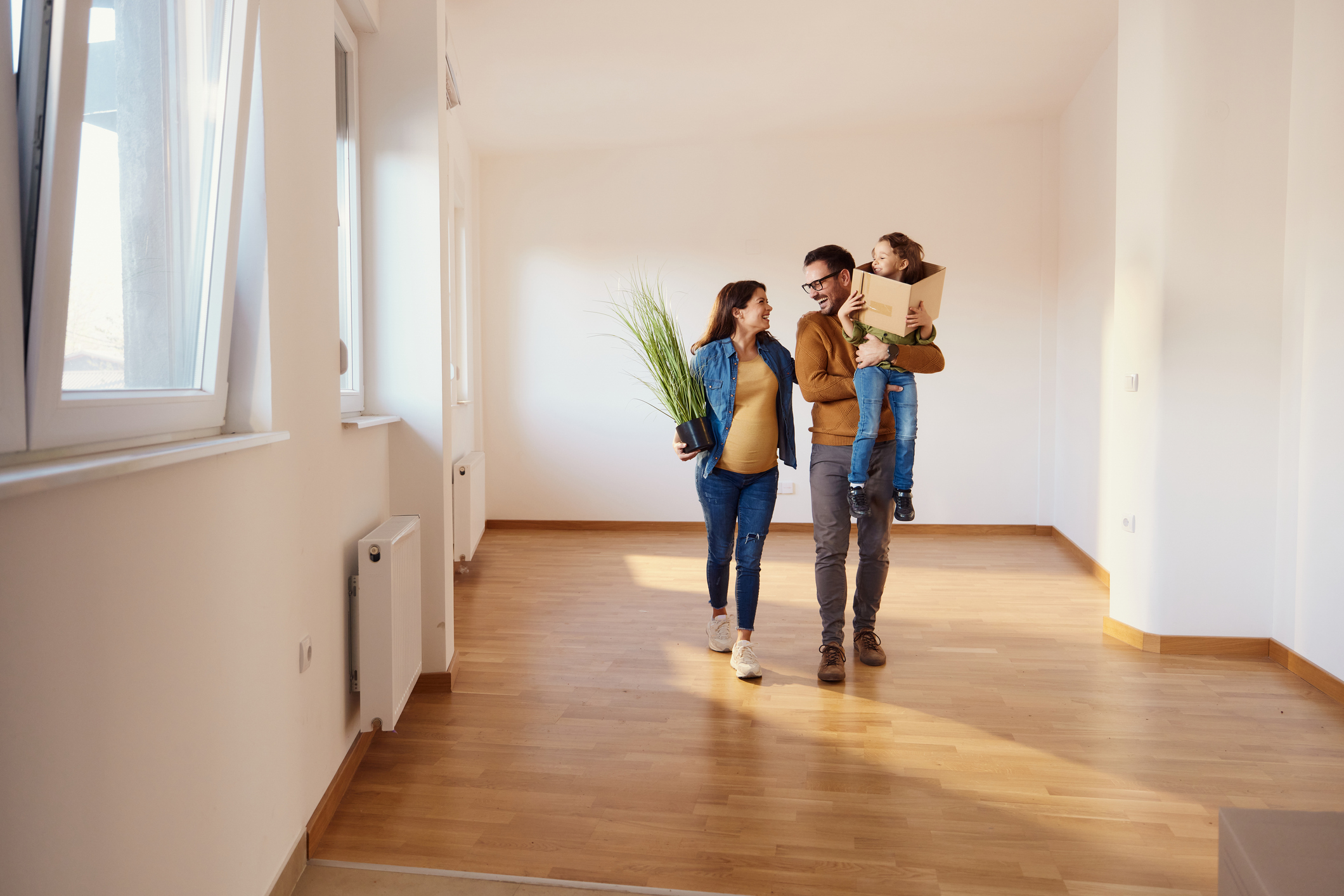 People smile while carrying boxes 