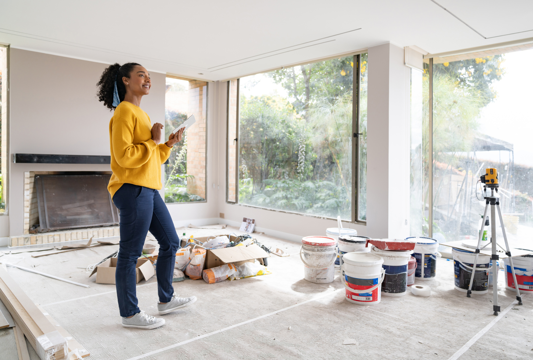 A woman smiles while renovating a h