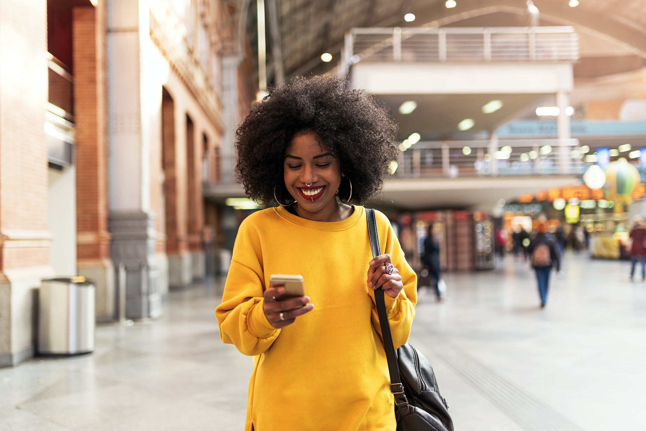 A woman smiling at a phone.