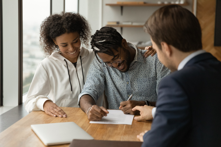 People smile while closing on a conventional loan.