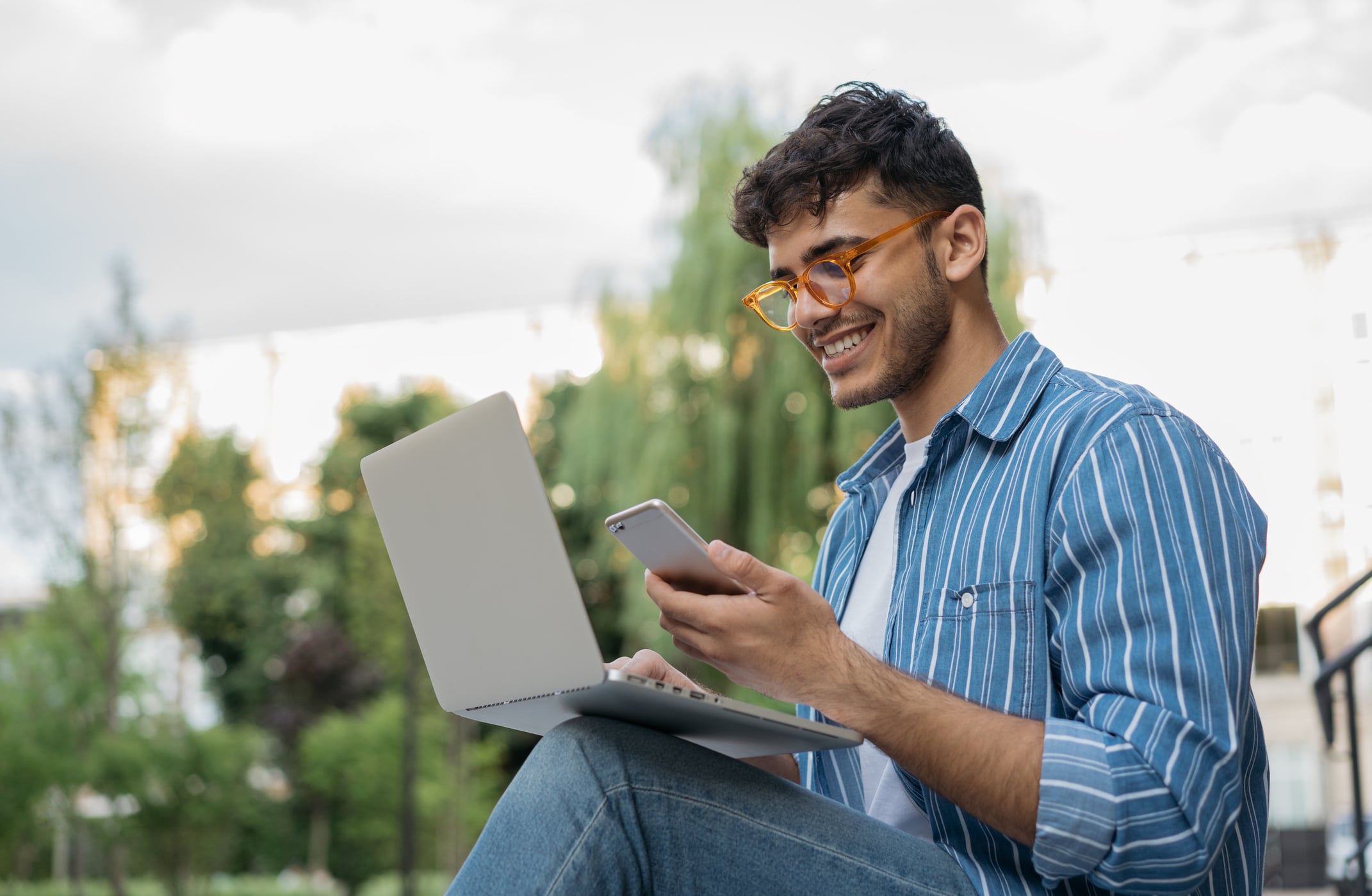 A man smiles at a phone while exploring HELOC options.