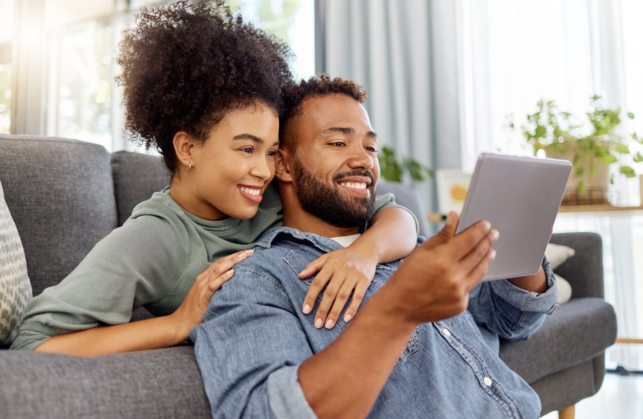 Man and woman smiling at a phone.