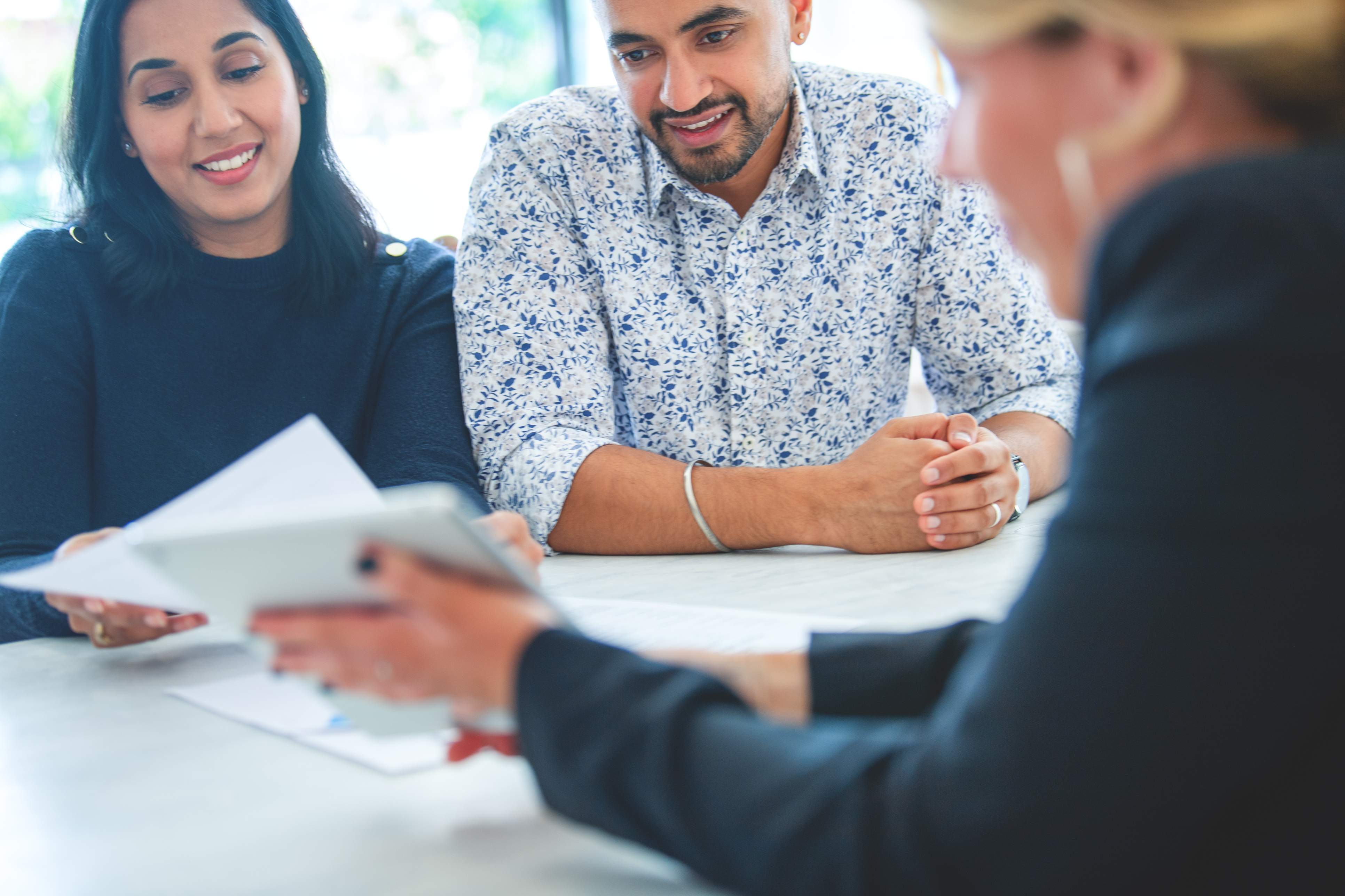 People smile while closing on an FHA loan.