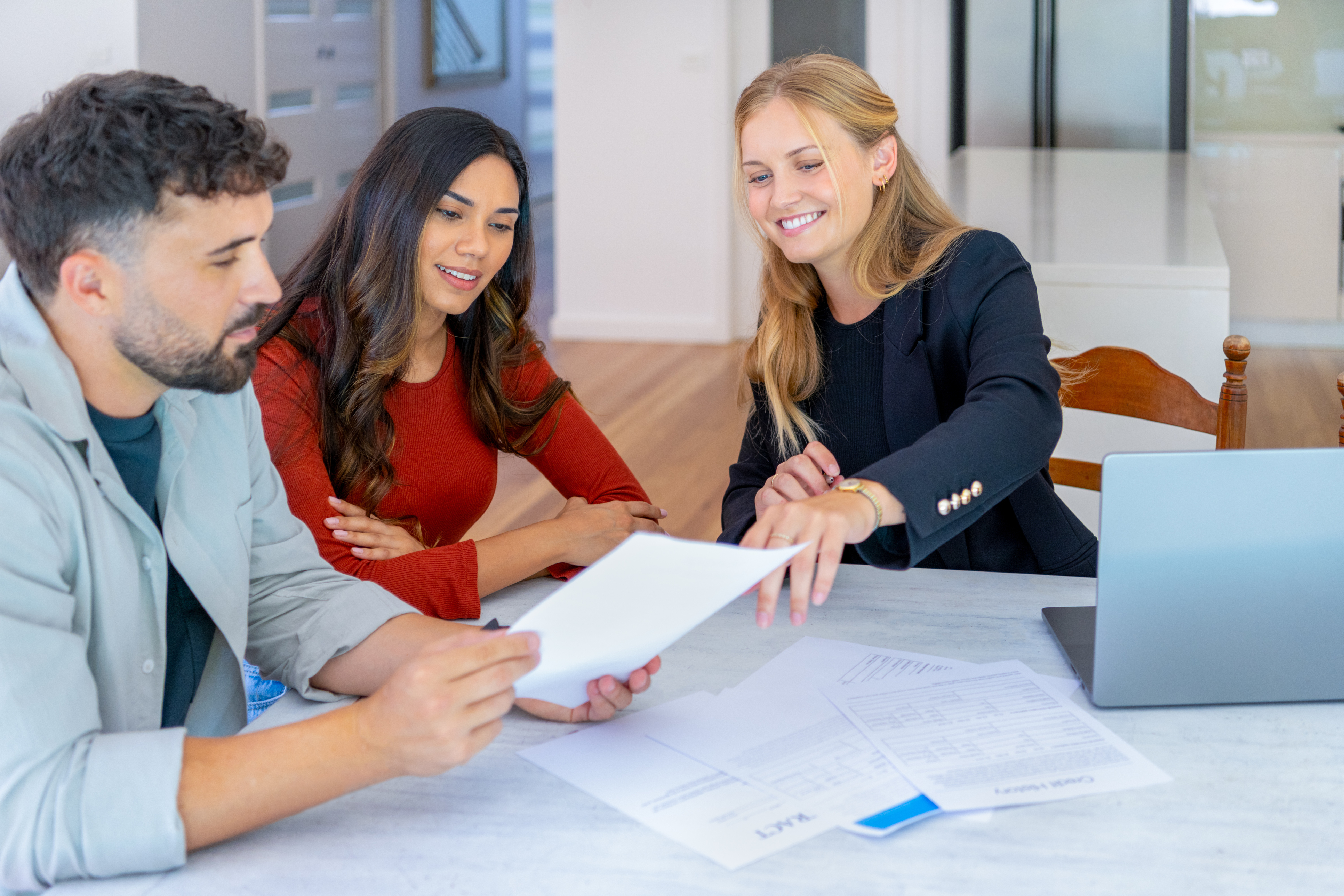 People smile while closing on a home loan.