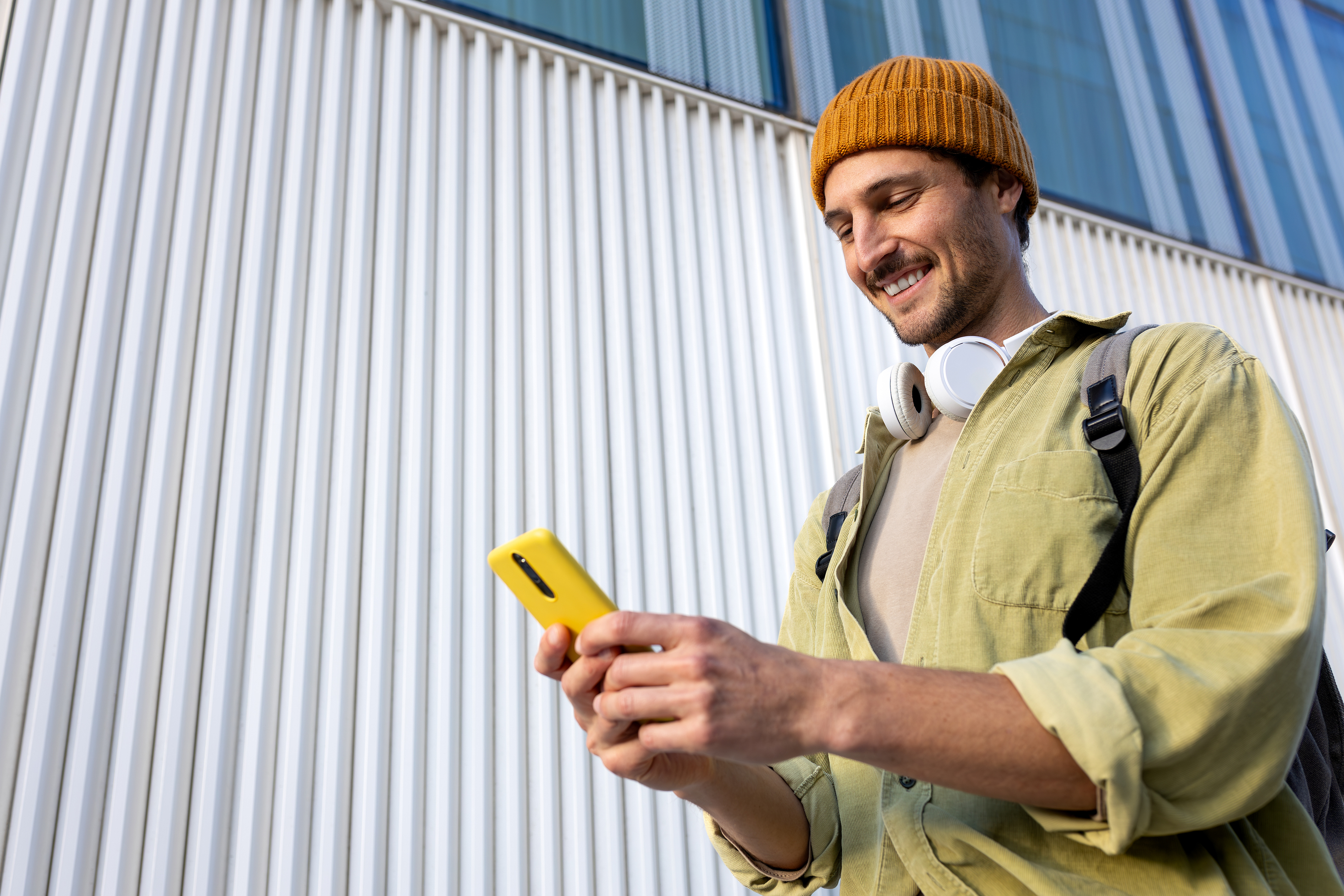 A man smiling at a phone.