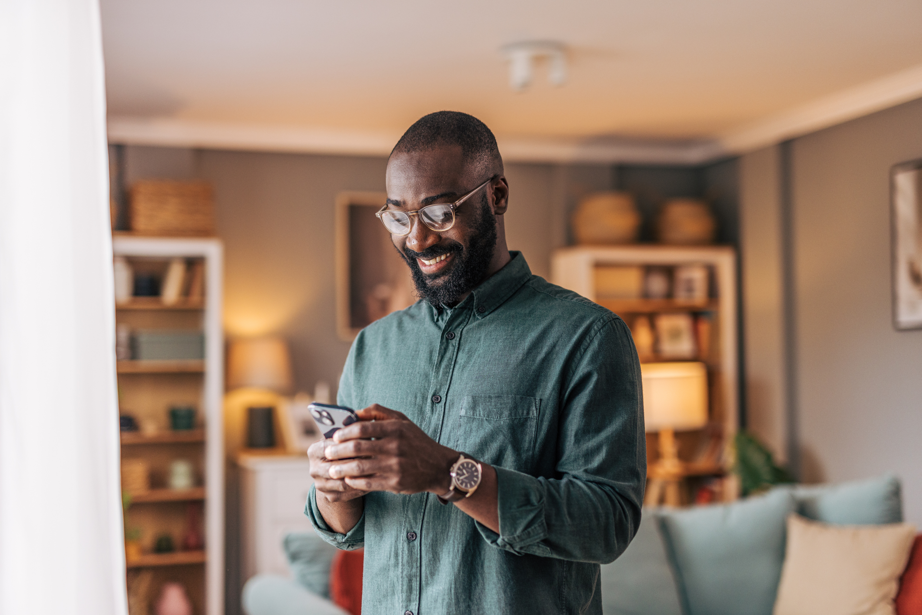 A man smiles at a phone while learning about DTI requirements for home equity loans.