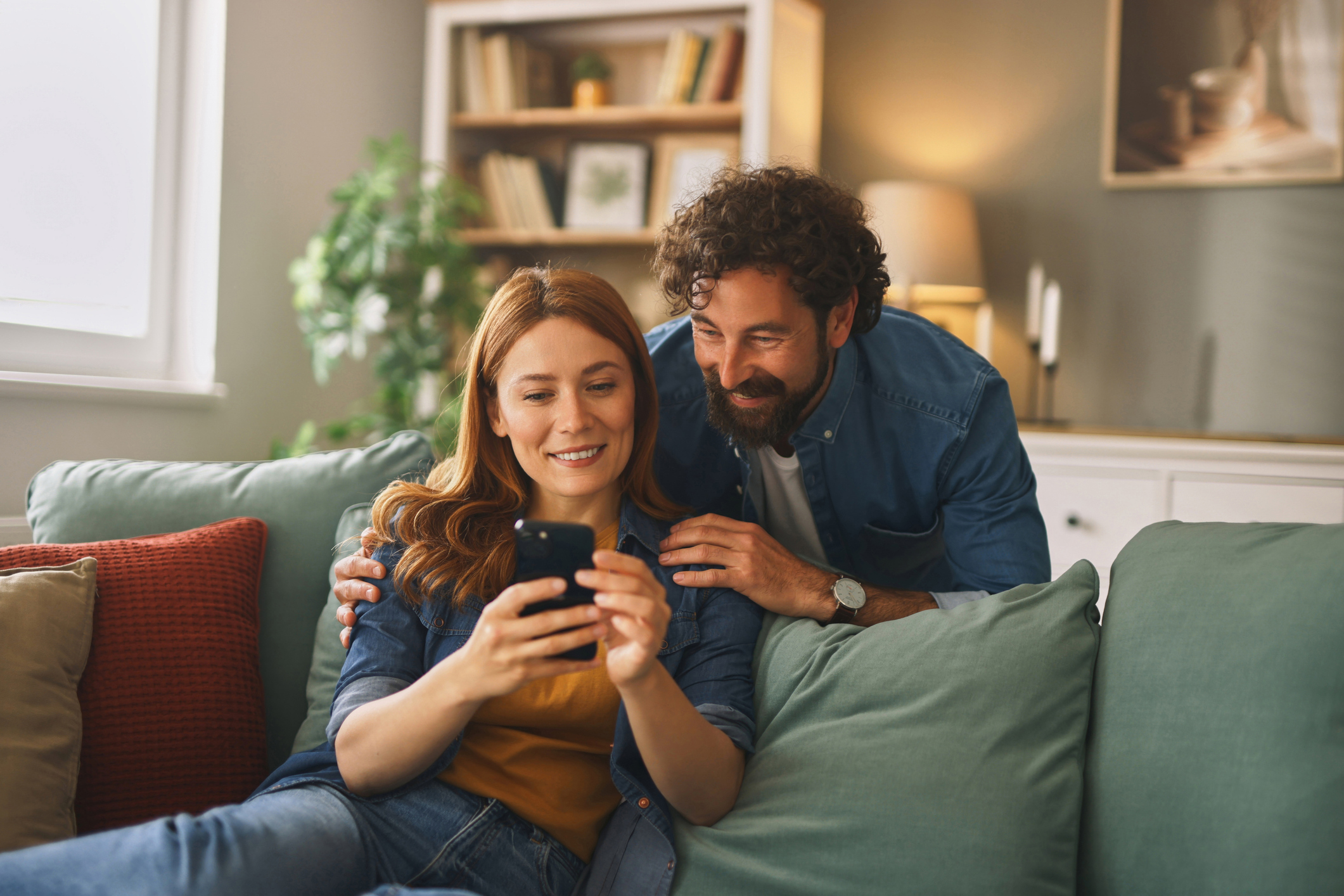 People smile at a phone.