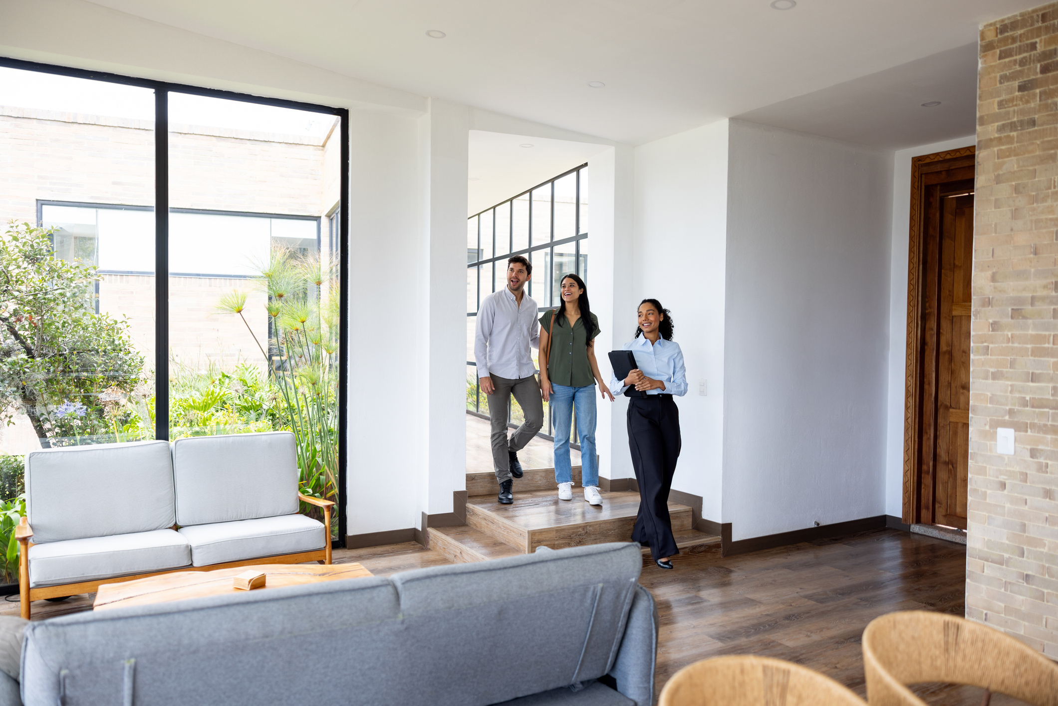 People smile while touring a house.
