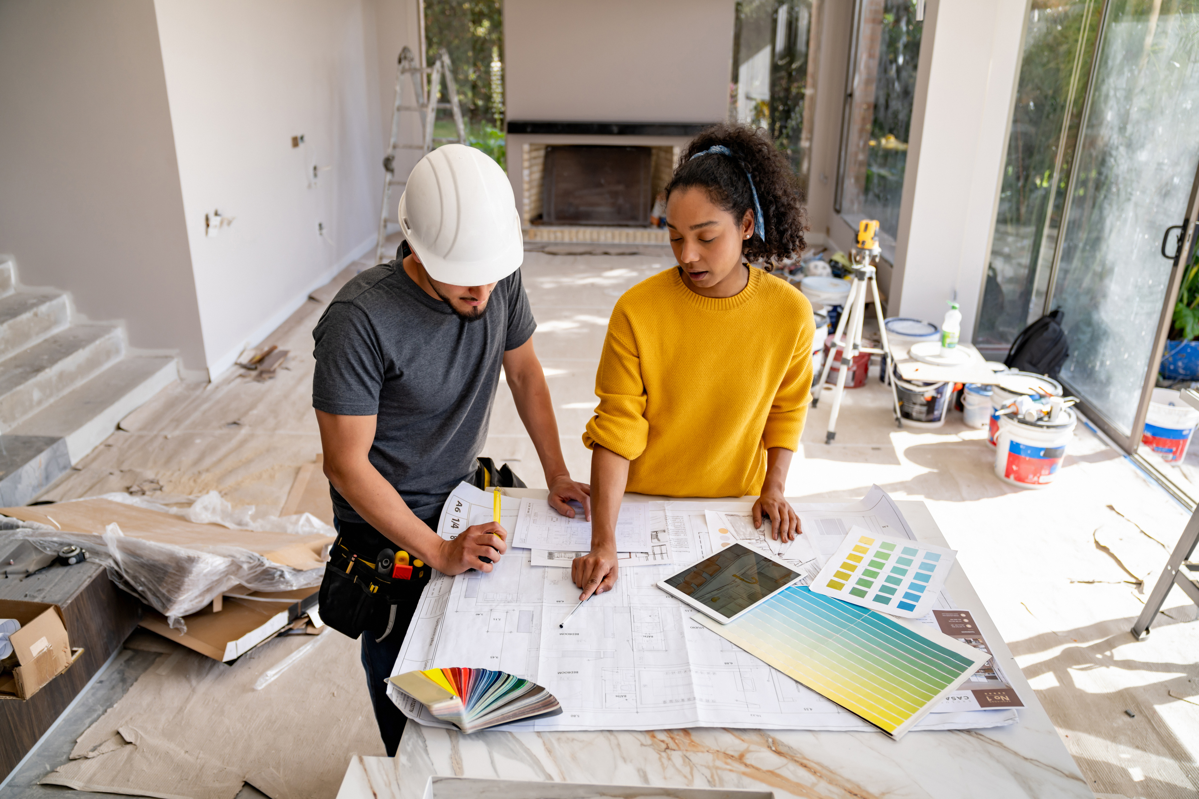 A woman goes over home renovation plans with a contractor.