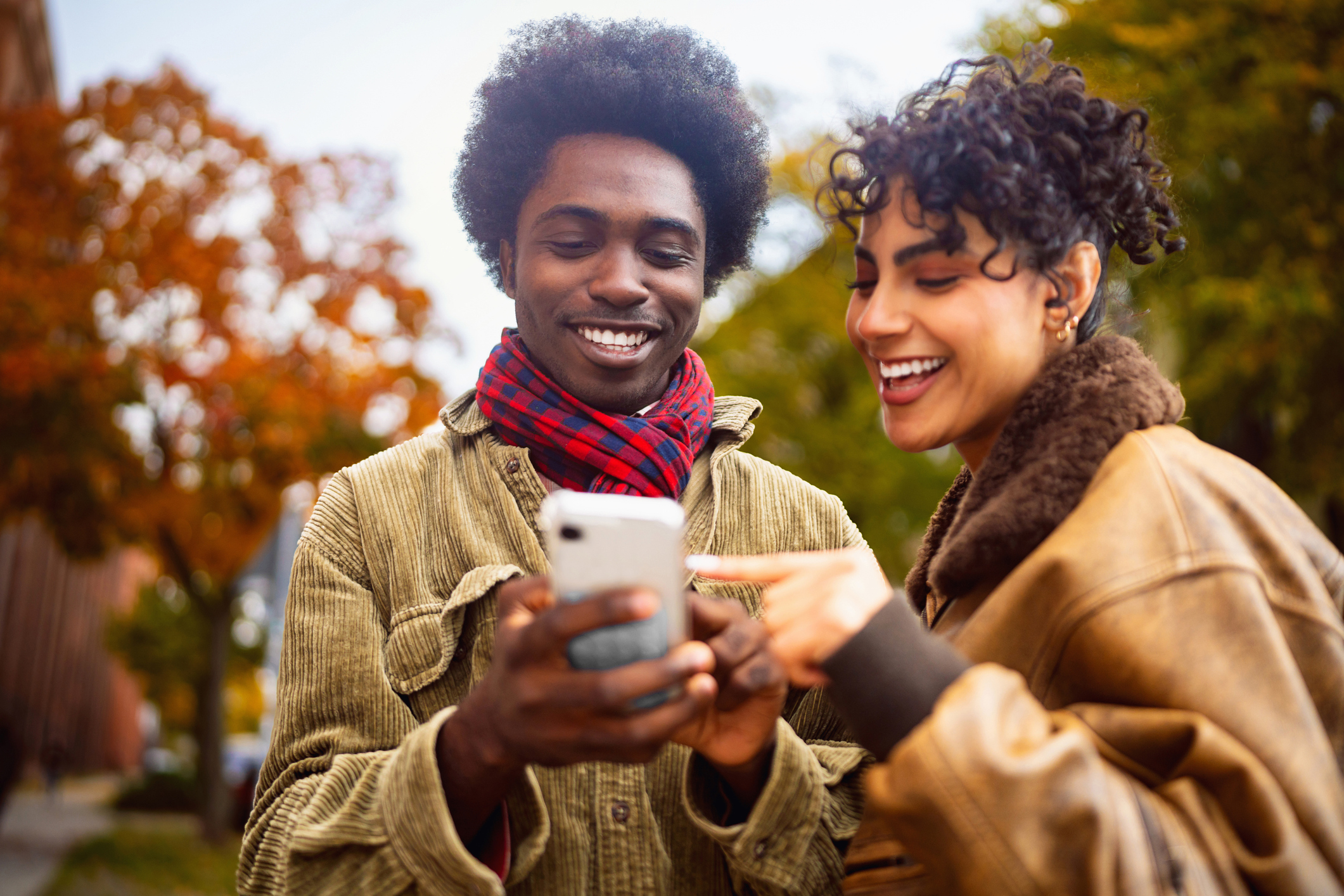 People smile at a phone.