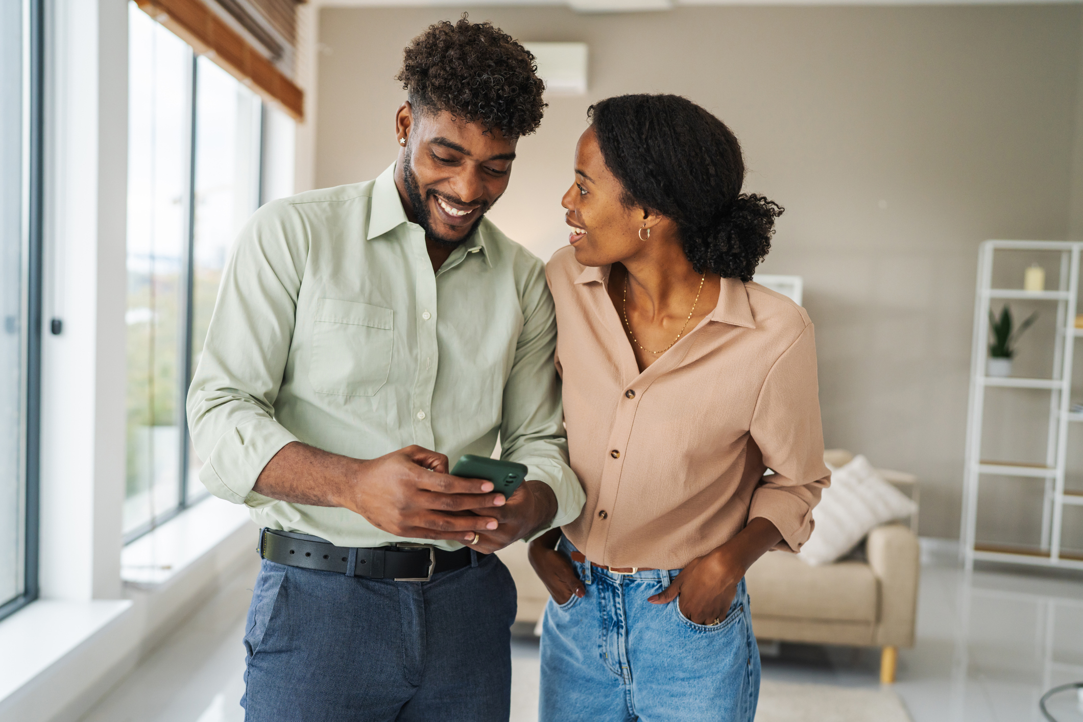 People smile at a phone.