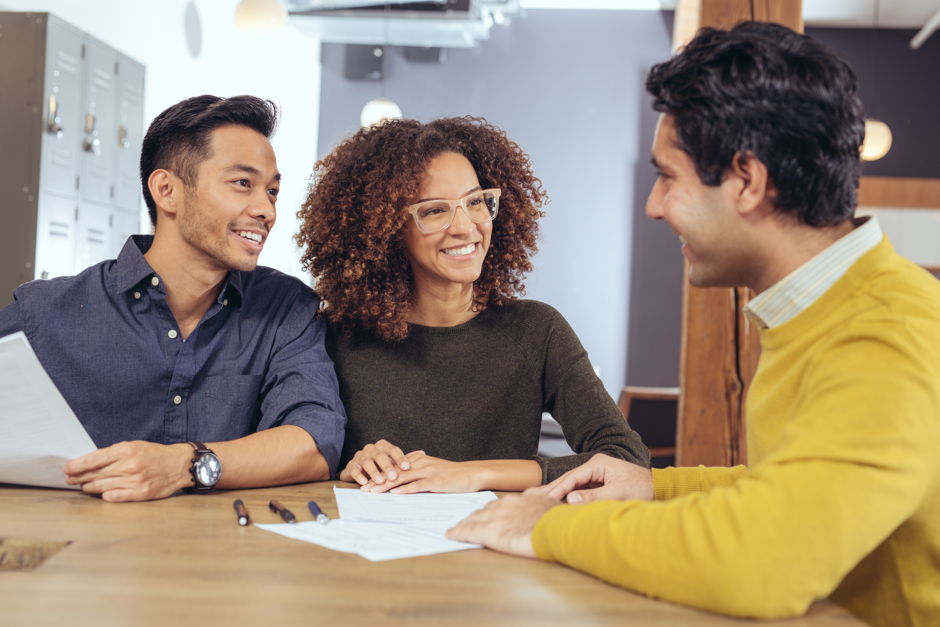 People smile while closing on their FHA loan.