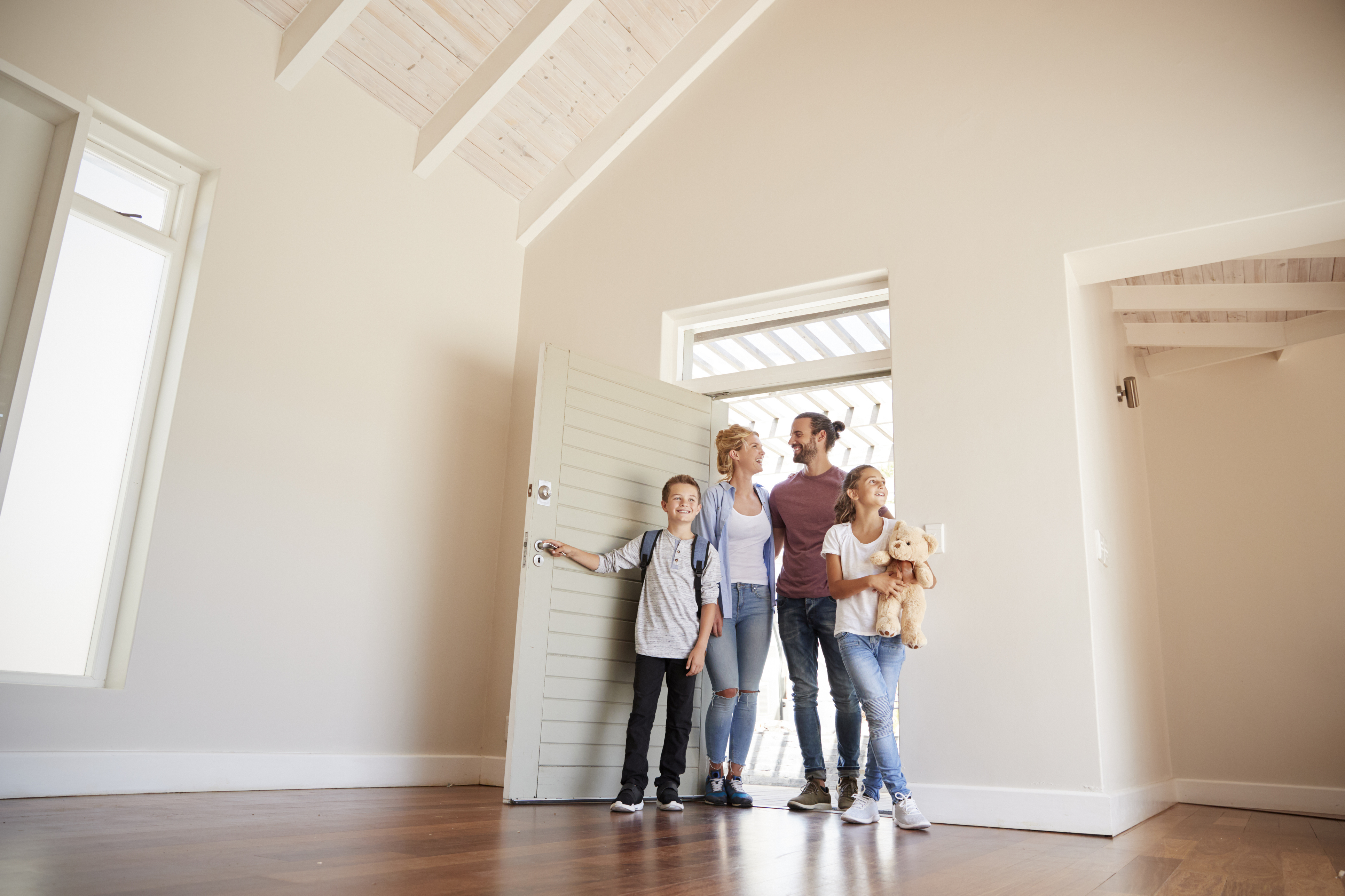 A family walking into their new home.