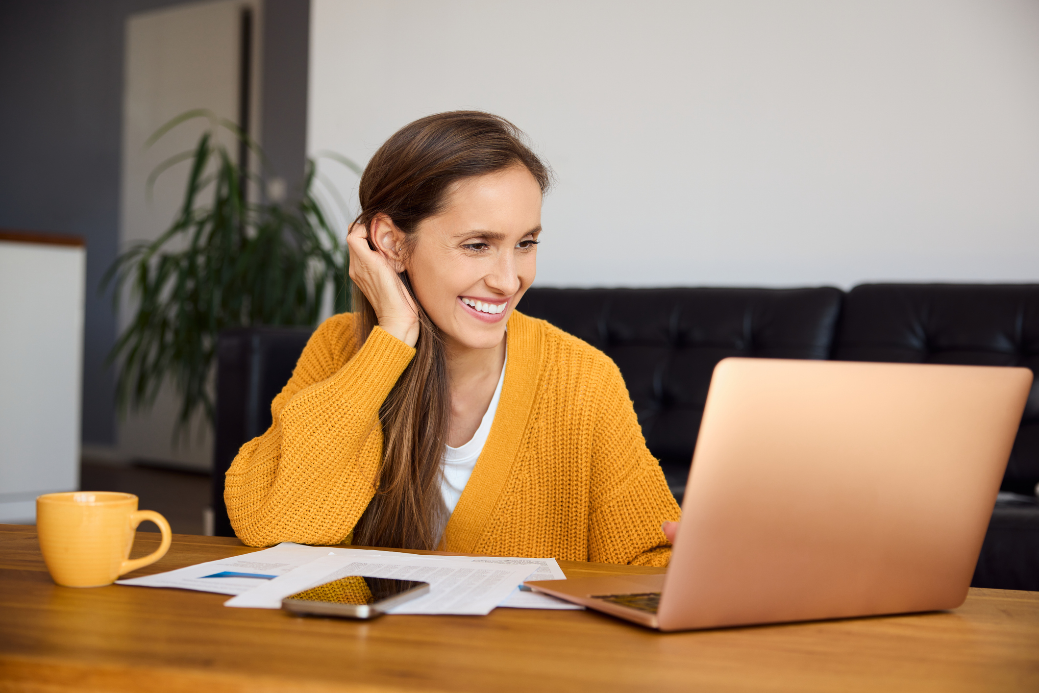 A woman smiles while shopping for a second home loan.